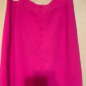 Hot pink button down skirt with a slit in the front.